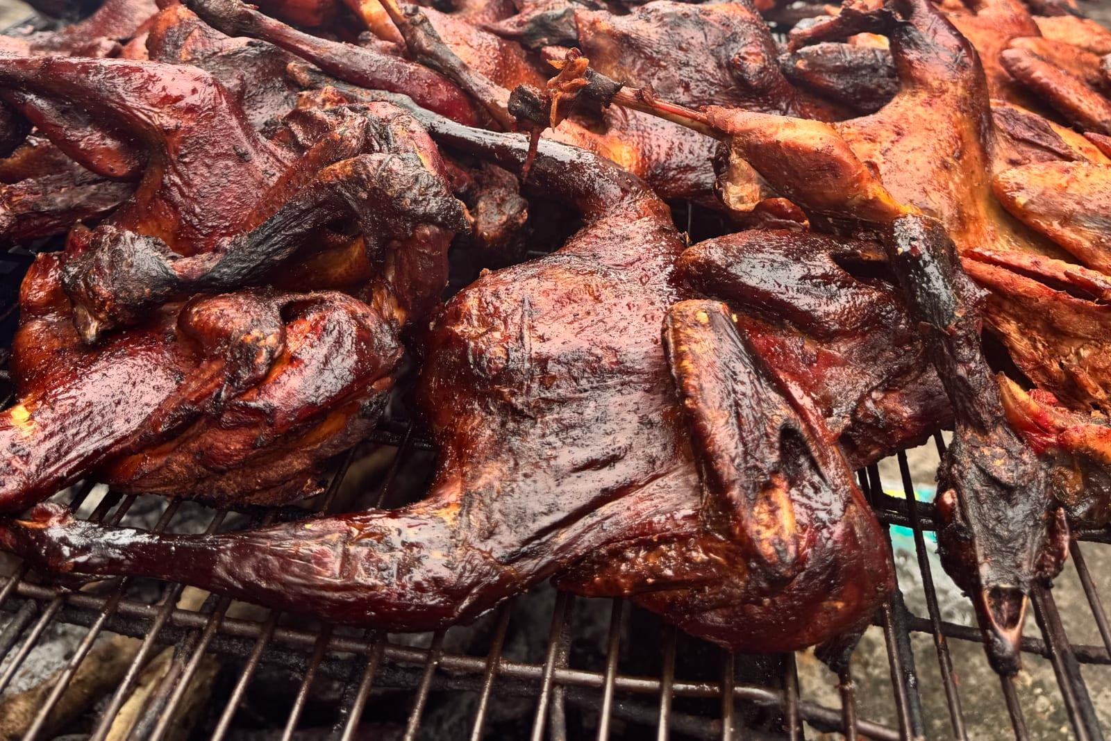 Smoked guinea fowl over open flame